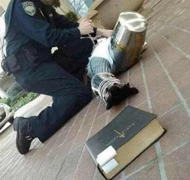 Arrested crusader reaching for book  Meme Template